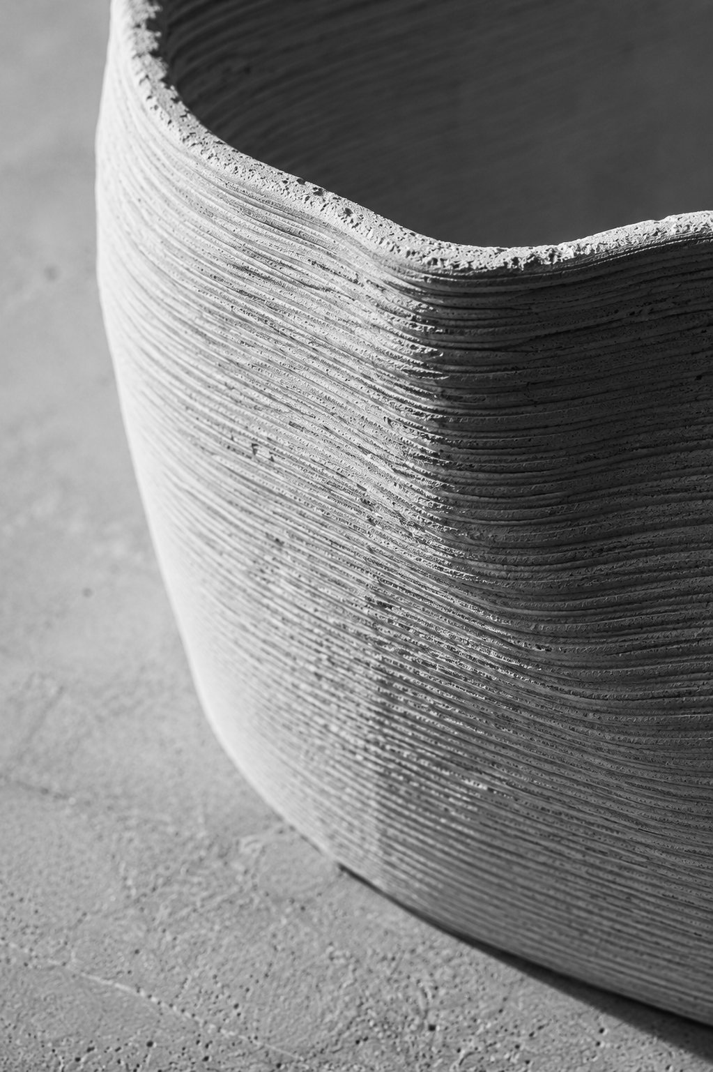Cast vessel on concrete surface — plaster form, parting seam retained, surface variance visible